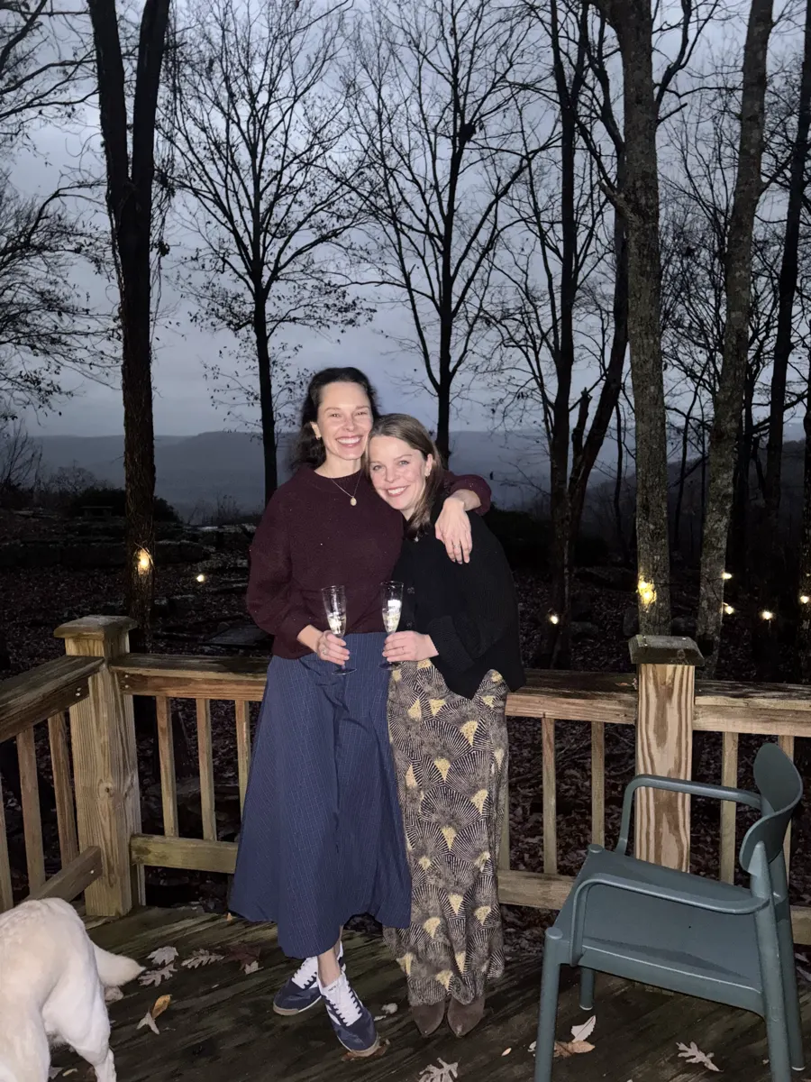 Champagne on the deck at dusk, one of the dogs sneaking into frame