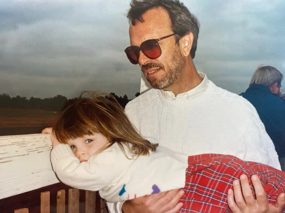 A childhood family photo of Shelby by the water