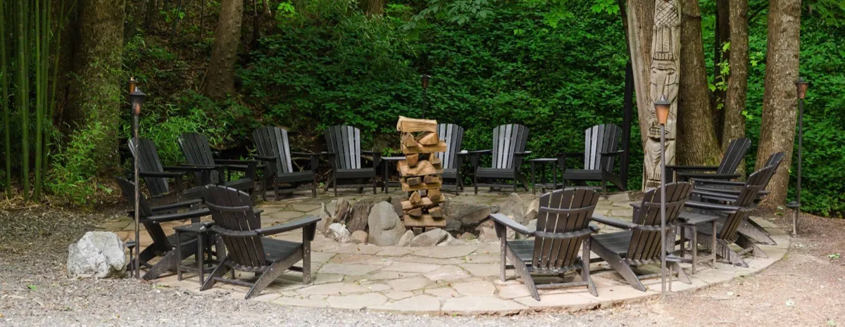 Adirondack chairs circled around the estate fire pit