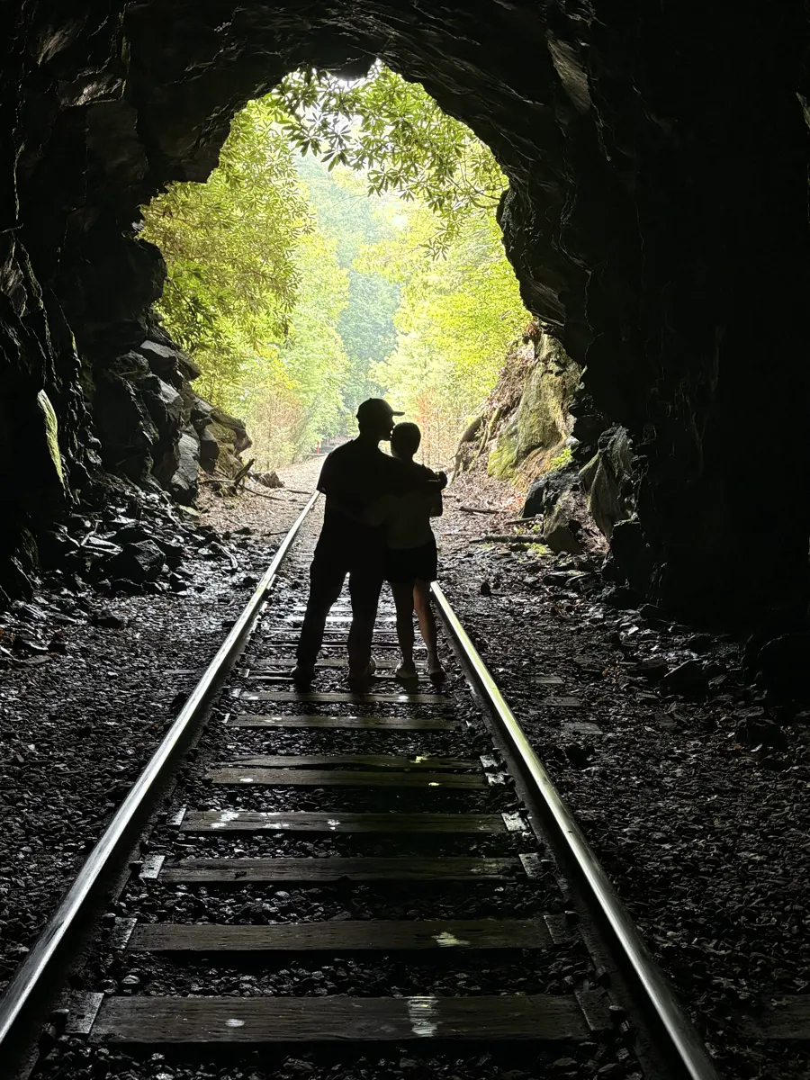 Silhouetted in the mouth of the 1894 railroad tunnel on the rail bike route
