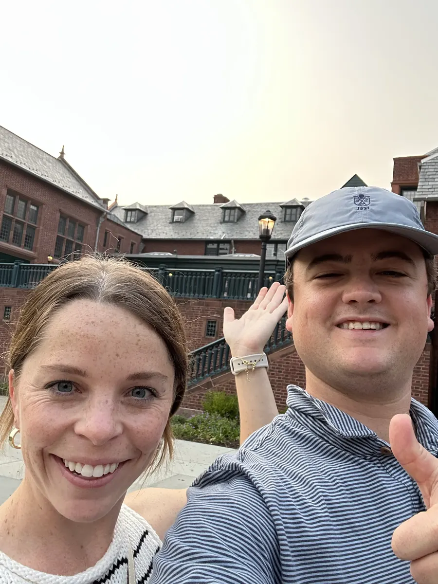 Shelby and Hobey waving in a selfie at dusk