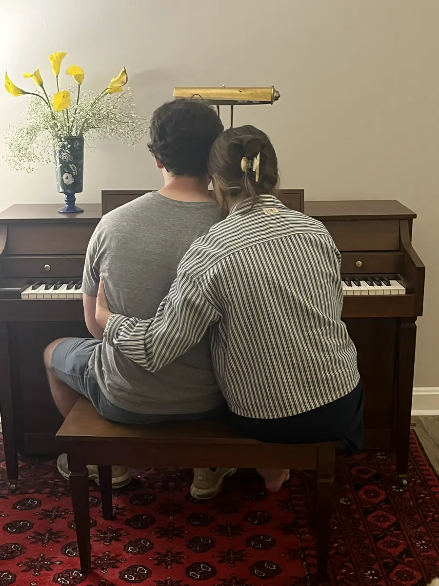 Shelby and Hobey sitting at the piano together
